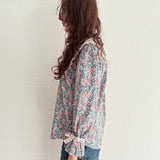 Sustainable vintage-inspired floral blouse with oversized collar and bow-detail cuffs
