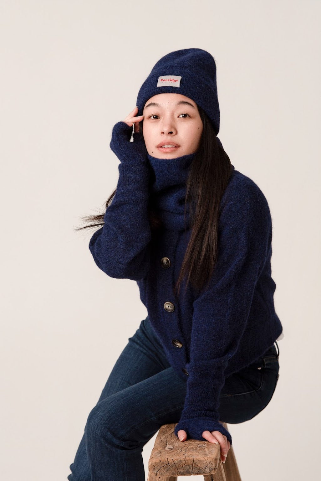 Side view of inky blue rib knit alpaca beanie showing soft texture