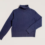 Close-up of fine knit admiralty navy turtleneck jumper with cropped fit