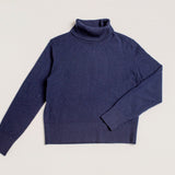 Close-up of fine knit admiralty navy turtleneck jumper with cropped fit