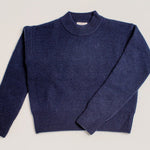 Close-up of chunky knit navy roll neck cropped jumper in soft wool cashmere