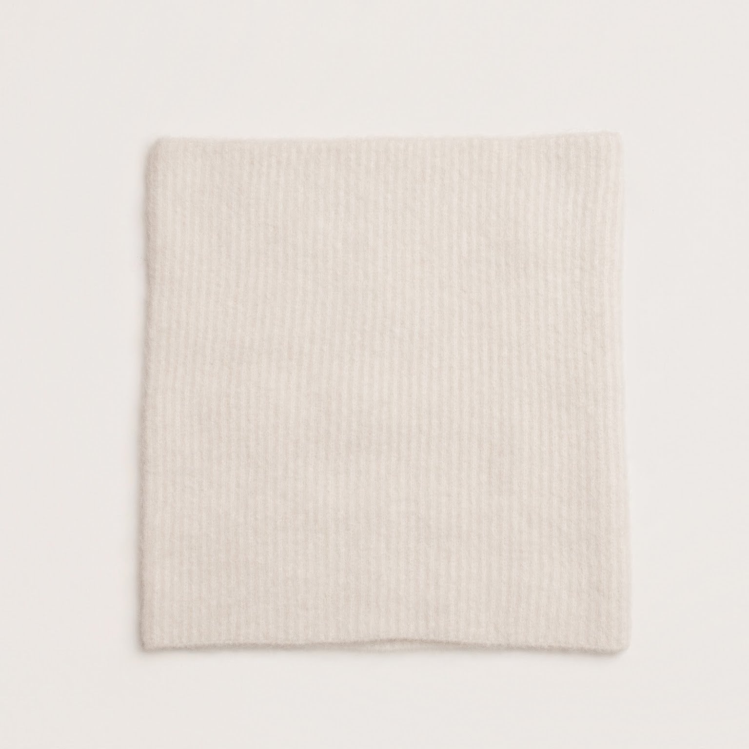 Soft rib knit alpaca snood in white showing cosy texture