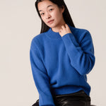 Close-up of blue wool cashmere cropped jumper with ribbed roll neck