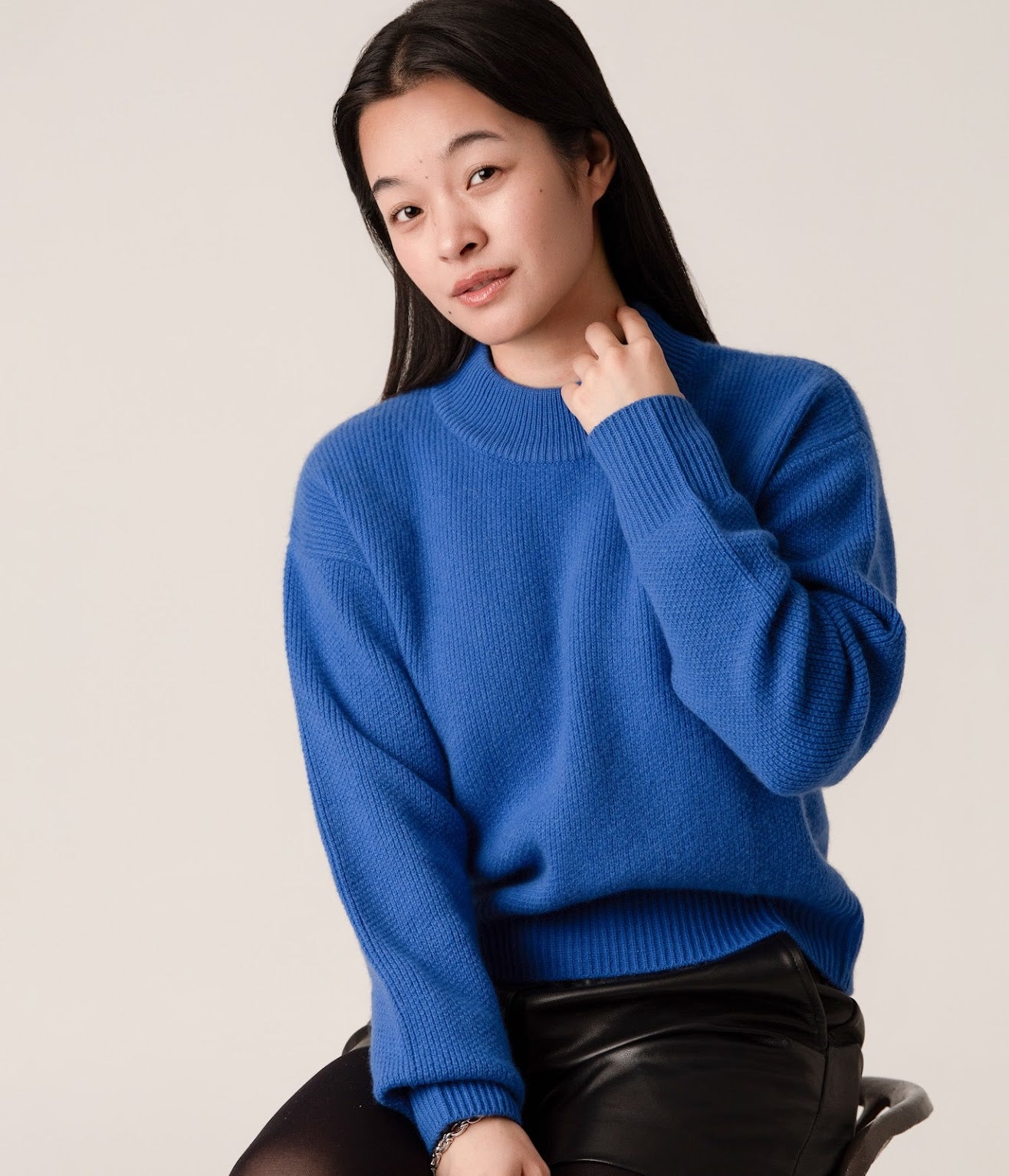 Close-up of blue wool cashmere cropped jumper with ribbed roll neck