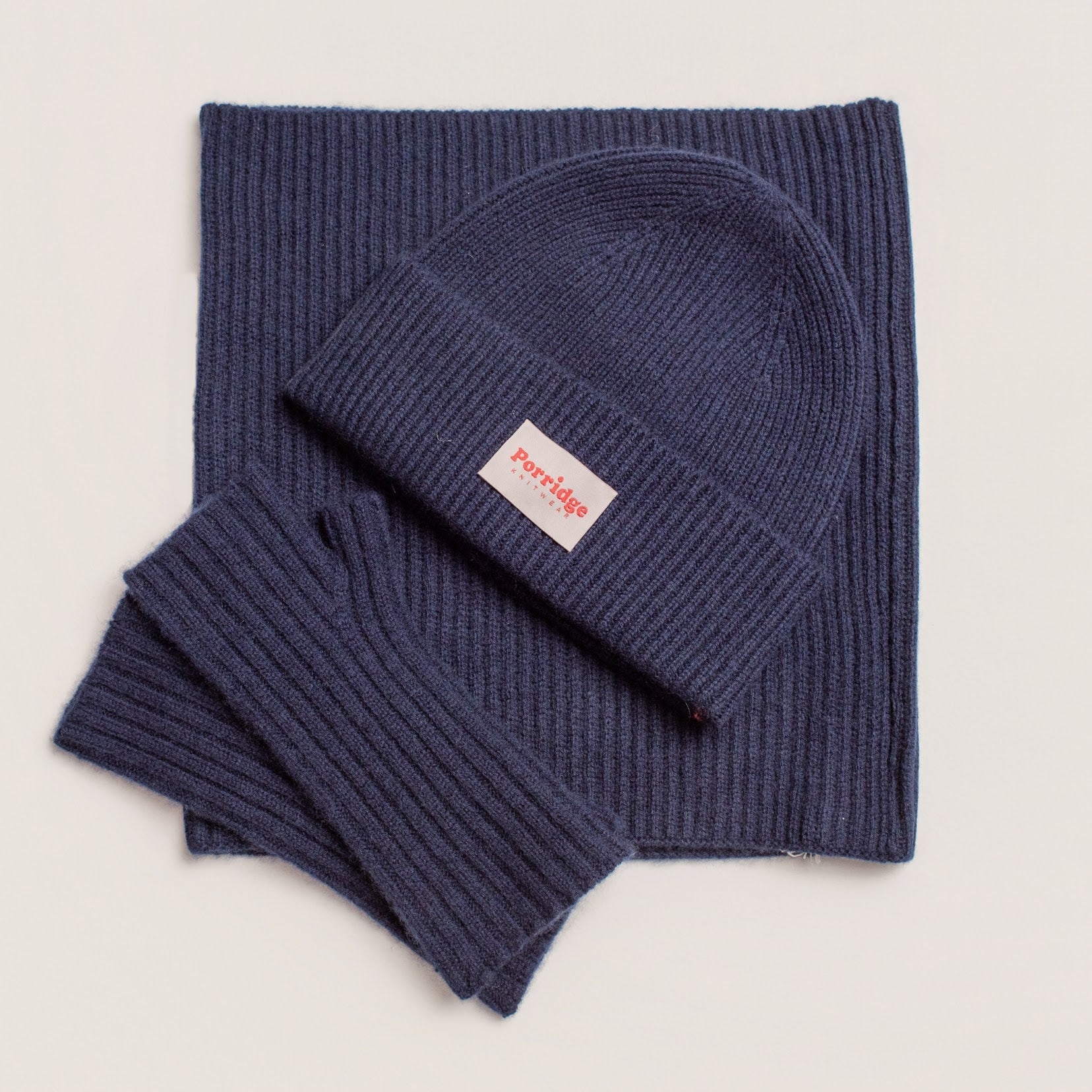 Navy cashmere beanie showing chunky rib texture and soft wool blend