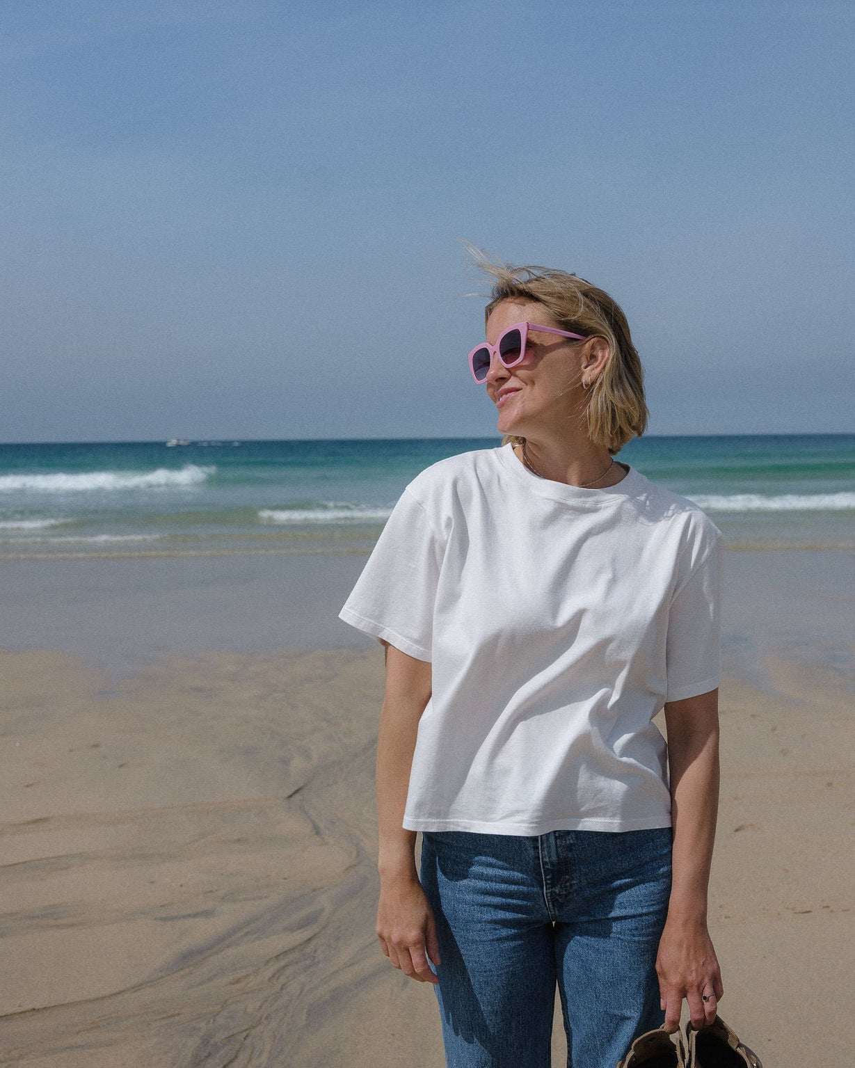 Colourful sunglasses in bright pink with bold frames and stylish design.