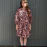 women wearing pink leopard dress