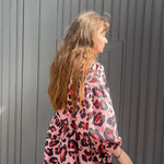 women wearing pink leopard dress details
