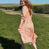 women in field wearing sustainable deadstock cotton midi dress
