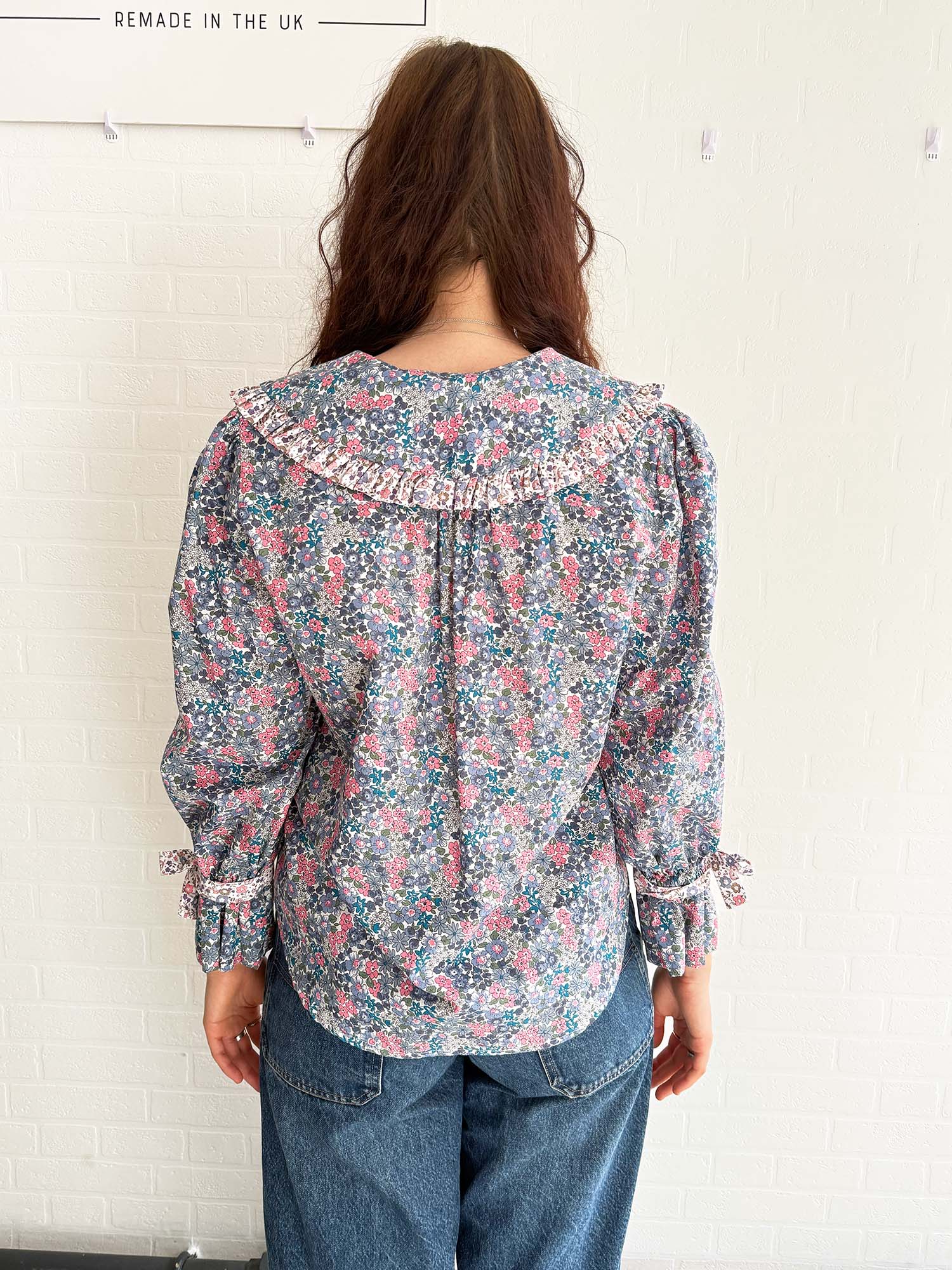 Romantic and effortless – model in lightweight floral print blouse made in the UK