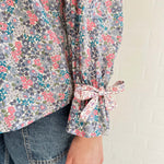 Slow fashion in action – model wearing feminine floral blouse with vintage buttons