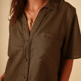 Stylish linen button down shirt with short sleeves paired with high waisted shorts in a matching set.