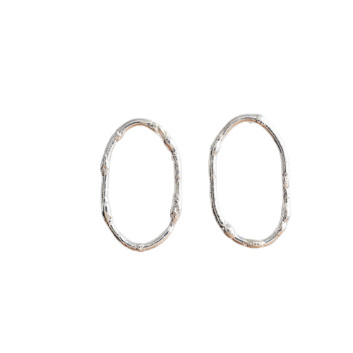 Textured loop earrings made out of recycled silver by April March Jewellery. Inspired by ancient coins, keepsakes and tokens, each earring is melted, hammered and textured by hand to give them a unique character and charm. Fashioned into a quirky and stylish loop to create a unique look. 