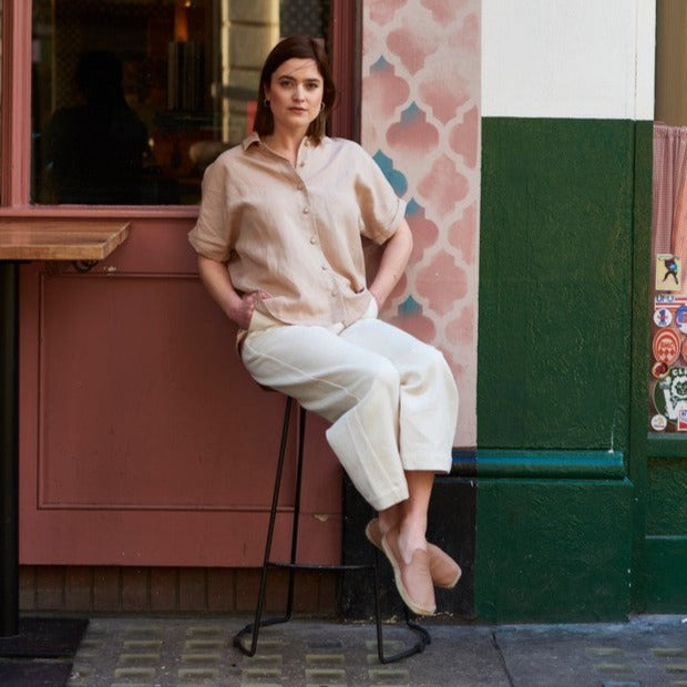A contemporary take on the classic linen shirt.  The short-sleeved shirt design features a relaxed and comfortable fit, with a cross pleat back and flattering dropped hem. Featuring a split side seam, traditional collar, and luxurious covered buttons. This bestselling shirt is a staple for a sustainable, long-lasting wardrobe.