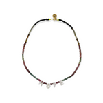 The Tourmaline Word Up necklace by Bella Riley. Exclusive to Percy Langley.  Handmade in Hackney by jeweller Bella Riley, maker of joyful Demi-fine jewellery. Bella’s designs beautifully balance classic and edgy.  Tourmaline beads in a rainbow of colours with mother of pearl letters.  Necklace is 17 inches and is finished with gold-plated clasp lined with signature neon beads and Bella Riley tag.