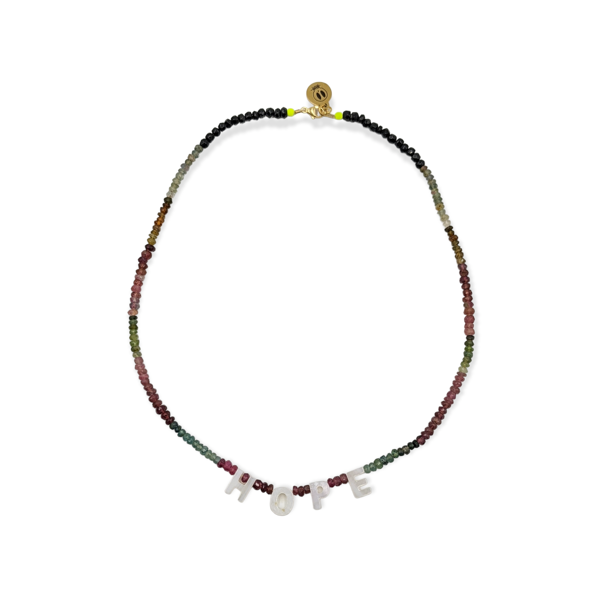 The Tourmaline Word Up necklace by Bella Riley. Exclusive to Percy Langley.  Handmade in Hackney by jeweller Bella Riley, maker of joyful Demi-fine jewellery. Bella’s designs beautifully balance classic and edgy.  Tourmaline beads in a rainbow of colours with mother of pearl letters.  Necklace is 17 inches and is finished with gold-plated clasp lined with signature neon beads and Bella Riley tag.