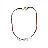The Tourmaline Word Up necklace by Bella Riley. Exclusive to Percy Langley.  Handmade in Hackney by jeweller Bella Riley, maker of joyful Demi-fine jewellery. Bella’s designs beautifully balance classic and edgy.  Tourmaline beads in a rainbow of colours with mother of pearl letters.  Necklace is 17 inches and is finished with gold-plated clasp lined with signature neon beads and Bella Riley tag.