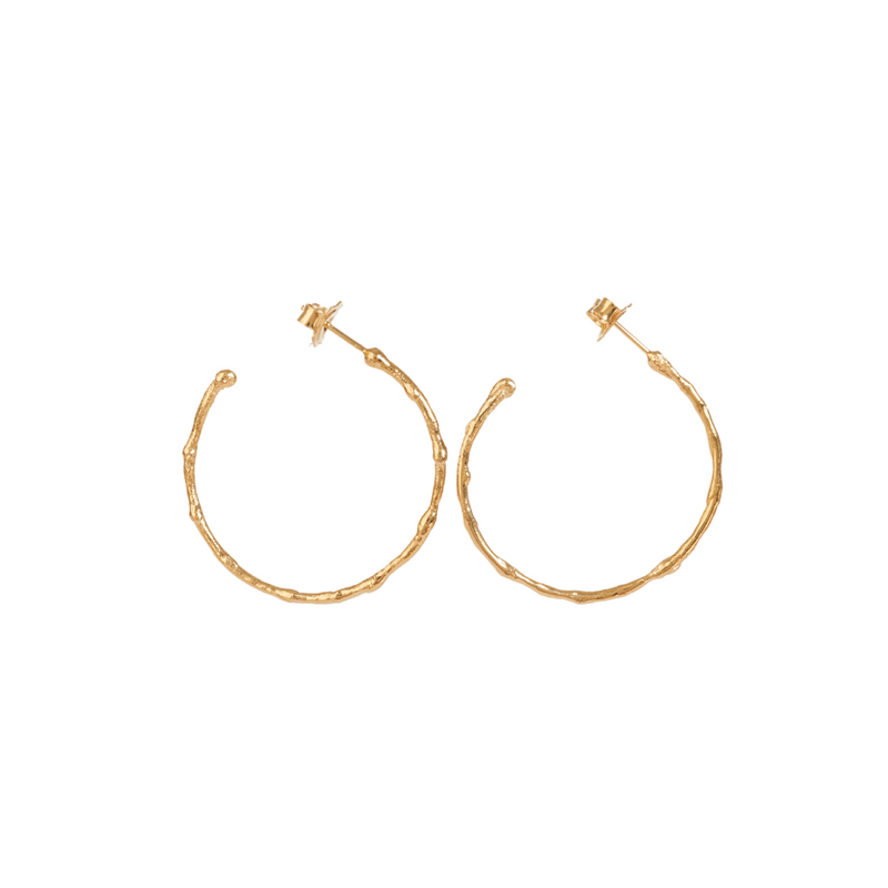 Medium textured hoops made out of recycled yellow gold by April March Jewellery. Inspired by ancient coins, keepsakes and tokens, each earring is melted, hammered and textured by hand to give them a unique character and charm. Stunning pieces of jewellery that you can dress up or down. 