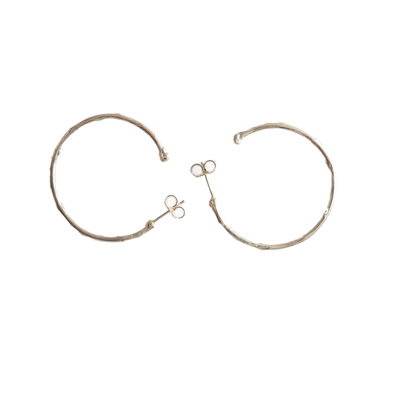 Medium textured hoops made out of recycled silver by April March Jewellery. Inspired by ancient coins, keepsakes and tokens, each earring is melted, hammered and textured by hand to give them a unique character and charm. Stunning pieces of jewellery that you can dress up or down. 