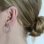 Medium textured hoops made out of recycled silver by April March Jewellery, sold by Percy Langley