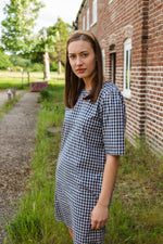 Comfortable cotton gingham check dress perfect for summer. The Gunnera Dress by Kate Sheridan is an effortless and versatile wardrobe staple. Featuring puff sleeves, side pockets and a loop button fastening at the back. 100% cotton, made in the North of England by Kate Sheridan.
