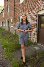 Comfortable cotton gingham check dress perfect for summer. The Gunnera Dress by Kate Sheridan is an effortless and versatile wardrobe staple. Featuring puff sleeves, side pockets and a loop button fastening at the back. 100% cotton, made in the North of England by Kate Sheridan.