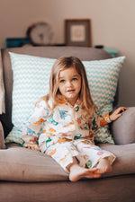 These vibrantly hand illustrated colourful dinosaur pyjamas are a favourite for kids, by Percy Langley