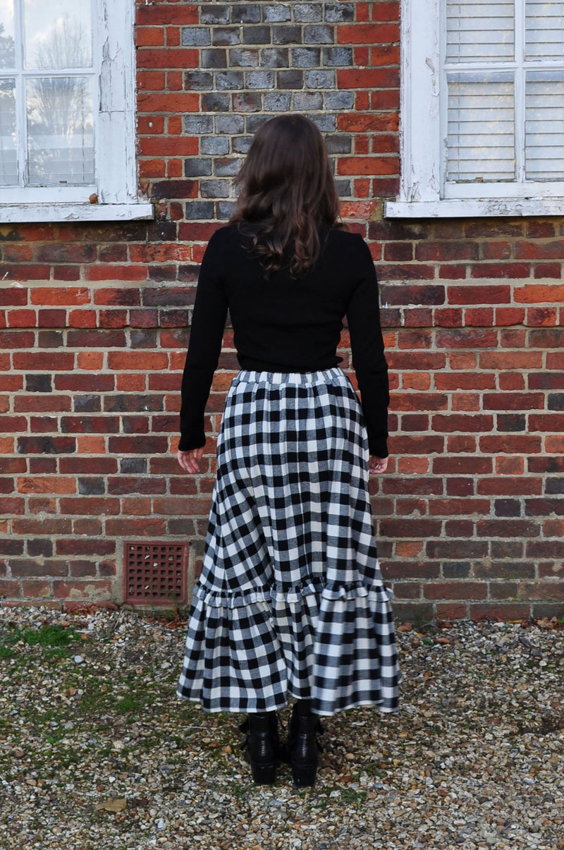 woman wearing gingham skirt back
