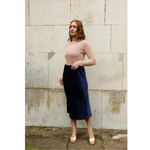 The Ridley navy blue satin slip skirt is an elegant bias cut midi length skirt in satin.   With a hidden elastic inside the waist band the skirt is easy to pull on, comfortable to wear and will become a well loved wardrobe staple, adored for the incredibly flattering fit. 