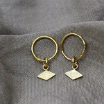 Textured earrings with a unique rhombus tag made out of fairmined gold vermeil by April March Jewellery, sold by Percy Langley