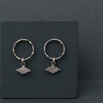 Textured shape earrings with a rhombus tag made out of recycled silver by April March Jewellery, sold by Percy Langley