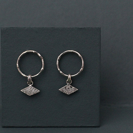 Textured shape earrings with a rhombus tag made out of recycled silver by April March Jewellery, sold by Percy Langley