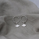 Textured shape earrings with a rhombus tag made out of recycled silver by April March Jewellery, sold by Percy Langley