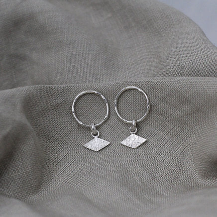 Textured shape earrings with a rhombus tag made out of recycled silver by April March Jewellery, sold by Percy Langley