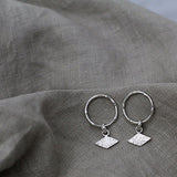 Textured shape earrings with a rhombus tag made out of recycled silver by April March Jewellery, sold by Percy Langley