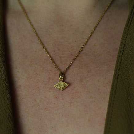 Textured shaped necklace with a rhombus tag made out of fairmined gold vermeil by April March Jewellery, sold by Percy Langley