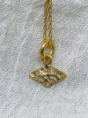 Textured shaped necklace with a rhombus tag made out of fairmined gold vermeil by April March Jewellery, sold by Percy Langley