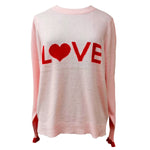 The Love Jumper by LAM in Pink/Scarlet has been intarsia-knitted with a luxury blend of cashmere and Extrafine Merino Wool to create this fun upbeat design.  The Puff shoulder and wider sleeve gives a feminine edge to this fun 70’s feel jumper. Featuring contrasting scarlet frill cuffs and back hem detail.  Teamed with wide leg shorts or bootcut jeans this jumper gives the perfect effortless look.
