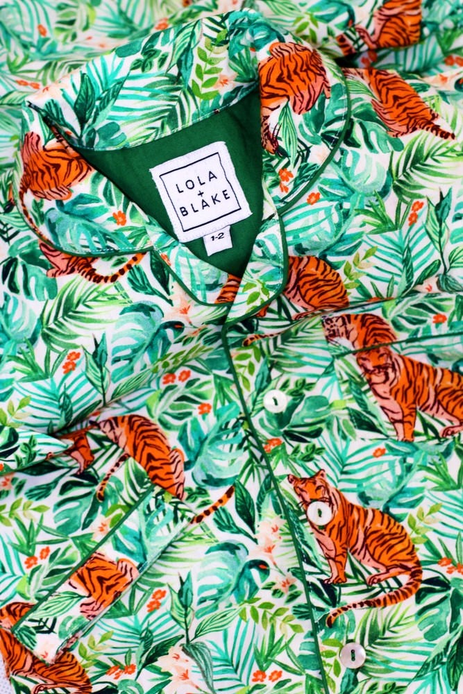 The jungle pyjamas are made from the finest 200 thread count, 100% cotton and finished with pearlised buttons, elasticated waist with a drawstring and a gorgeous emerald green piping for a classic look. 